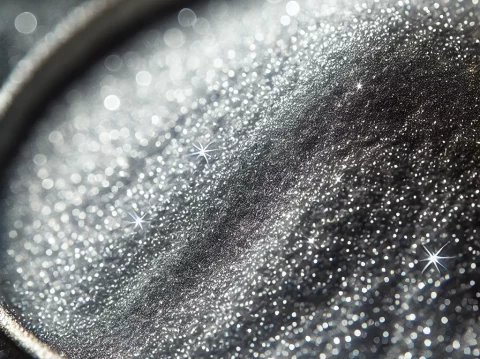 Silver-coated copper powder, finely and evenly spread across the surface, resembling delicate dust particles. The powder should have a bright silver m Silver-coated copper powder, finely and evenly spread across the surface, resembling delicate dust particles. The powder should have a bright silver m